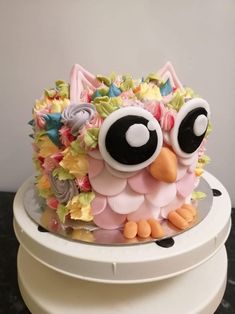 a cake decorated with an owl and flowers