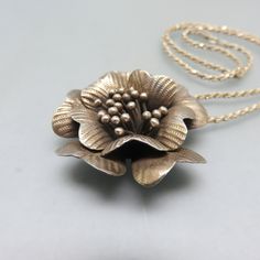 This vintage sterling silver floral pendant and chain are so beautiful. The pendant is so very detailed and lifelike that you can almost smell it. The flower measures 1 3/4 inch high and wide. T The bale is marked 925. The chain is sterling as well and marked 925 . It measures 16 inches long. Both pieces are in excellent condition. The pendant and chain weigh in at 22.20 grams of sterling silver. We will send this to you in a lovely gift box for stellar presentation. If you like vintage silver j Vintage Necklace With Flower Pendant, Vintage Antique Silver Flower Pendant Jewelry, Vintage Silver Flower Shaped Necklace, Vintage Silver Flower-shaped Necklace, Antique Flower Charm Pendant Jewelry, Vintage Flower-shaped Nickel-free Necklaces, Vintage Hallmarked Flower Pendant Necklace, Vintage Jewelry With Flower Charm And Pendant, Vintage Sterling Silver Flower Necklace