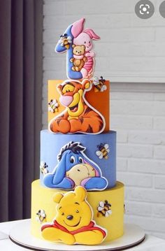 a winnie the pooh birthday cake on a table