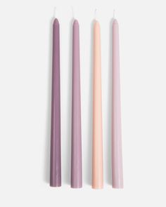 three different colored candles sitting next to each other