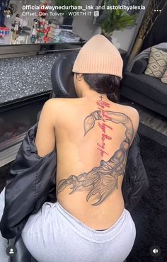 a woman with a tattoo on her back