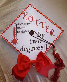 a graduation cap with the word mother written on it and a red ribbon tied around it