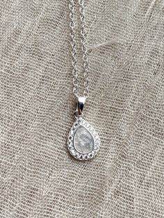 Gorgeous sterling silver pendant with CZ crystals, set with the ashes of your loved ones.  Ashes are set with high quality synthetic opals and industry leading resin.  Comes with 18in chain.  Please follow instructions here for sending ashes: https://www.orphictreasures.co.uk/post/how-to-send-inclusions-memorial-jewellery Silver Pendant Birthstone Necklace For Wedding, Silver Necklace With Birthstone For Keepsake, Silver Teardrop Birthstone Necklace For Gift, Silver Birthstone Teardrop Pendant Crystal Necklace, Silver Teardrop Crystal Necklaces For Gift, Silver Gemstone Necklaces For Keepsake, Silver Teardrop Crystal Necklace Gift, Silver Engraved Birthstone Necklace Keepsake, Silver Birthstone Teardrop Pendant Necklace