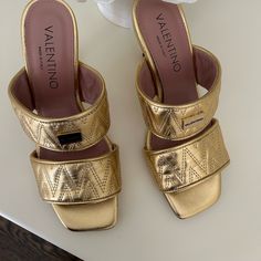 Valentino Never Worn Brand New With Box And Duffle Bag. Beautiful Gold Color In A Size 8. Elegant Open Toe Sandals For Shopping, Luxury Gold-tone Hardware Sandals For Spring, Luxury Summer Heels With Gold-tone Hardware, Spring High Heel Sandals With Gold-tone Hardware, Luxury Gold Mules With Block Heel, Summer High Heel With Gold-tone Hardware, Summer High Heels With Gold-tone Hardware, High Heels With Gold-tone Hardware For Summer, Luxury Gold Open Heel Mules