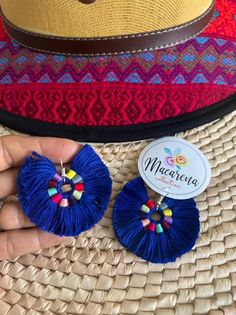 Earrings made of cotton thread, forming a fan full of colors Ideal for any style Huichol art and handicrafts are recognized worldwide and are setting trends, shaping the artistic work together with tradition. For the Huichol not working in the field or livestock, handicrafts susbsistir is the way, in this work the whole family works and children start learning the art of jewelry, about five years, starting only crimping the accounts in the simplest designs of necklaces and earrings, then continu Bohemian Beach Flower Earrings With Colorful Beads, Bohemian Dangle Flower Earrings For Beach, Bohemian Flower Earrings For Beach, Multicolor Bohemian Earrings For Fiesta, Handmade Hippie Earrings For Beach, Mexican Flower Earrings, Bohemian Red Flower Earrings With Colorful Beads, Bohemian Blue Flower Earrings, Colorful Beaded Flower-shaped Earrings For Gifts