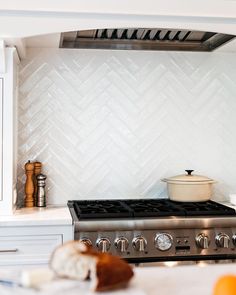 a stove top oven sitting inside of a kitchen next to an oven hood and counter