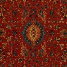 a red rug with an ornate design on the middle and bottom, in various colors