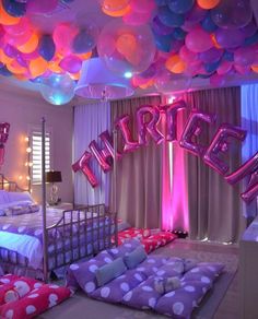 a bedroom decorated with balloons and bedding