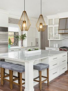 a kitchen island with two stools next to it