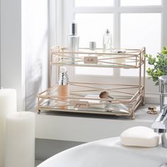 a bath room with a sink and a mirror next to a window in front of a window