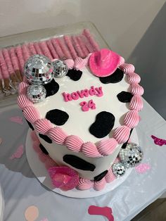 a birthday cake decorated with pink and black decorations