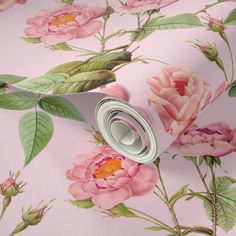 a pink flowered wallpaper with green leaves and flowers on the bottom half of it