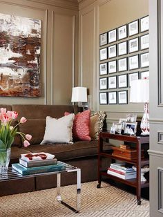 a living room filled with lots of furniture and flowers in vases on the coffee table