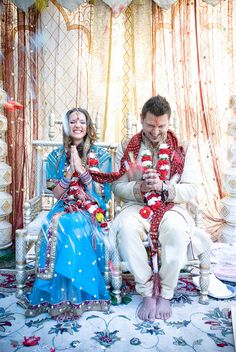 a man and woman sitting on top of a chair