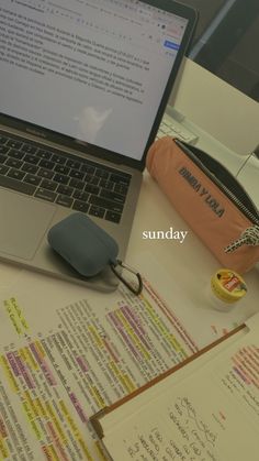 an open laptop computer sitting on top of a desk next to a mouse and notebook