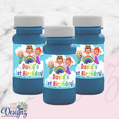 three bottles of blue liquid with the name david's 1st birthday on it and rainbows