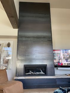 a living room with a large metal fireplace