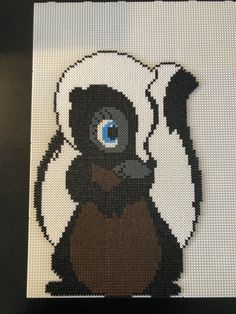 a cross stitch picture of a monkey with blue eyes on it's back side