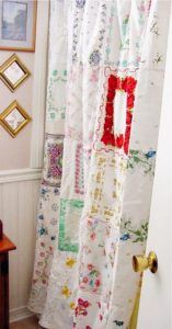 a bathroom with a shower curtain covered in patchwork