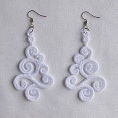 white lace earrings with spiral design on them