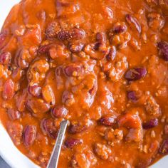 a white bowl filled with chili and beans