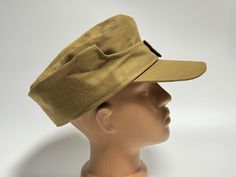 a mannequin head wearing a tan hat