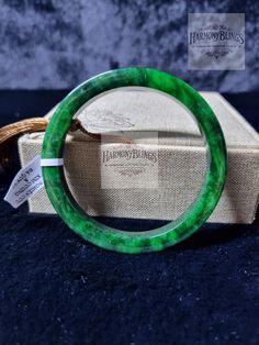 Certified Grade A natural jadeite bangle with a vintage design. Perfect as a Christmas or New Year gift. Elegant and sophisticated, this green jade bracelet complements any outfit beautifully. The set includes an elegant jewelry box, the jadeite bangle, and a certificate of authenticity ensuring it's genuine and completely natural. The bangle is exquisitely crafted by skilled artisans, featuring perfect deep green stone veins. This is a carefully selected piece just for you. The bangle comes in Spiritual Green Bangle Bracelet, Handmade Green Jade Bangle, Adjustable Green Jade Bangle, Green Spiritual Bangle As A Gift, Spiritual Green Bangle As A Gift, Handmade Round Jade Bangle, Spiritual Jade Bangle For Gift, Vintage Jade Round Bracelets, Vintage Round Jade Bracelets