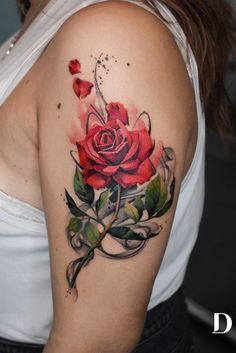 a woman with a rose tattoo on her shoulder