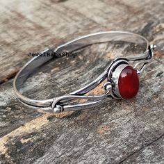 Bestseller garnet bangle, 925 sterling silver plated jewelry, handmade bangle for women, january birthstone, adjustable bangle, gift for her  Handmade bangle Gemstone- Garnet (hydro) Material- Brass, Gemstone  Use for - unisex Color- Red Polish- silver SHIPPING TIME- Usps Service : 10-15 business days - Express : 6-7 business days                                                                                   Our Shop Link (https://www.etsy.com/shop/JewelbabaShop?ref=seller-platform-mcnav) Red Polish, Malachite Jewelry, Gemstone Bangle, Handmade Bangles, January Birthstone, Adjustable Bangle, Polish Silver, Silver Plated Jewelry, Birthday Gifts For Women