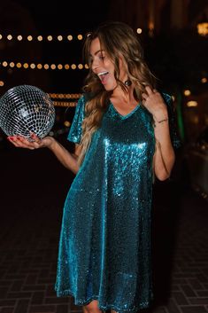 Get ready to sparkle in THE SEQUIN SHIFT DRESS IN AQUA. With its shimmering blue sequins and flattering shift cut, this is the perfect party dress for any occasion, especially New Year's Eve. Add some fun and glam to your wardrobe with this must-have dress! Aqua blue colored sequin V-neck Short sleeve Mini length Hidden side pockets Fully lined Zip up back 95% polyester, 5% spandex Pink Desert Brand Runs true to size. X-Small (00-2), Small (2-4), Medium (6-8), Large (8-12), X-Large (12-14), XX-L Sequin Shift Dress, Pink Desert, Perfect Party, New Year's, Aqua Blue, Shift Dress, Must Haves, Party Dress, Zip Ups