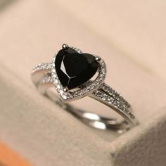 a black and white diamond ring in a box