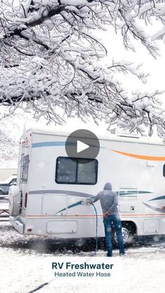 a man is washing his rv in the snow