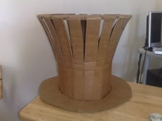 a cardboard hat sitting on top of a wooden table