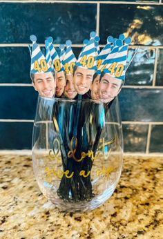 three men wearing party hats are in a wine glass with straws on it and the words happy birthday to you printed on them