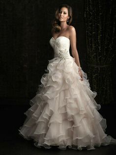 a woman in a wedding dress posing for the camera