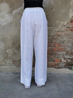 "White Linen Pants, Wide Leg Linen Pants, ✥ Welcome to my world! I create my design in my dreams and I draw geometric lines and extravagant patterns with scissors, needles and thread. Be my dream catcher and let me create for you a parallel fashion world! ✥ SHIPPING Express shipping: 2-3 biz days via DHL Worldwide ✥ SIZING The model in the picture wears size M. Height: 5'9\" and weigh 60 kg. Available sizes: XS - 3XL Please, refer to my Size Chart below to find your perfect size match! Keep in m White Straight Pants With Elastic Waistband, White Non-stretch Ankle-length Wide Leg Pants, White Linen Full-length Bottoms, White Harem Pants With Pockets For Loungewear, White Non-stretch Wide Leg Pants, White Straight Leg Daywear Pants, White Straight Leg Pants For Daywear, White Wide Leg Bottoms For Daywear, Wide Leg White Bottoms For Daywear