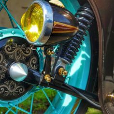 a close up view of the front end of a motorcycle with a yellow light on it