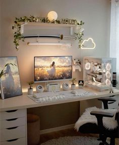 a desk with a computer on top of it next to a white chair and window