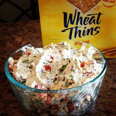 a bowl of food next to a box of wheat thins