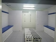 an empty room with white walls and blue shelves