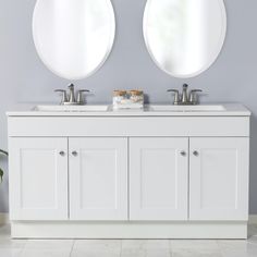 two round mirrors are above the double sinks in this white sink vanity with matching cabinetry