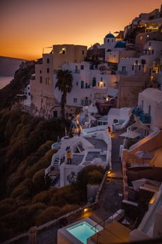 the sun is setting over some white buildings