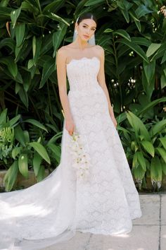 a woman in a wedding dress holding a bouquet