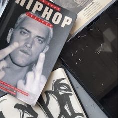 a close up of a magazine with a person on the cover and other items around it