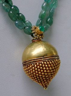 "An exclusive beautiful tribal pendant necklace from Rajasthan northern India. We sourced this piece of gem from a well known tribal family on the outskirts of Jodhpur. Solid well made 22 karat Gold sphere , the bottom half has tiny granulation ending with a tiny ball, the top half is quite shiny finish, set with a natural high grade Columbian emerald and strung with Emerald oval shape (cabochon) and gold beads. Ending with a beautiful gold s clasp. Total length-48 cm(18.72\")we can adjust lengt Traditional Ceremonial Pendant Beaded Necklaces, Traditional Ceremonial Beaded Pendant Necklaces, Traditional Ceremonial Beaded Pendant Necklace, Pendant Beaded Necklaces For Rituals And Festivals, Traditional Pendant Beads For Jewelry Making, Festival Pendant Jewelry With Gemstone Beads, Traditional Jewelry With Large Beads In Round Pendant, Traditional Large Beads Round Pendant Jewelry, Traditional Necklace With Large Beads And Round Pendant