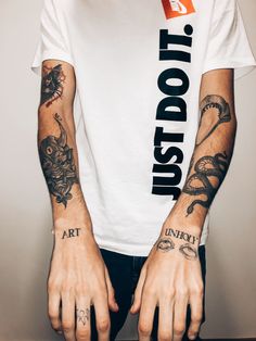 a man with tattoos on his arms and hands