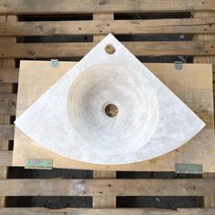 a white sink sitting on top of wooden pallets