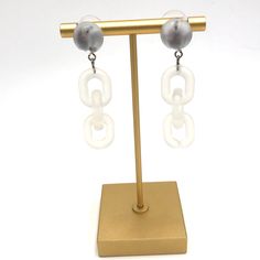 Moonglow button studs meet frosted lucite chain in these retro meets modern statement earrings. Each earring measures just under 2.25" or 58mm in length & are super light weight. Earrings are made with mostly vintage lucite parts that were made in the US in the 1960's - early 80's. We hand-set them with surgical steel earring posts and they have sturdy surgical steel/acrylic backings on them as well. Modern White Lucite Jewelry, Trendy White Drop Clip-on Earrings, Trendy White Metal Clip-on Earrings, White Plastic Earrings For Parties, Trendy White Plastic Earrings, Modern White Resin Earrings, Trendy White Earrings, Button Studs, Surgical Steel Earrings