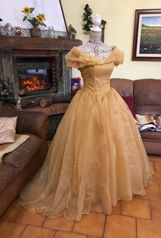 This costume is inspired by Belle's ball gown. The standard color is pale gold; if you prefer a different shade, please contact me so we can check on the availability The dress has a full skirt made of 8 layers of fabric including organza, tulle and duchesse satin; the bodice features a built-in bra and plastic boning, with a corset closure in the back. Everything will be professionally lined and finished. Measurements required are: - height - shoulders to floor (optional) - bust - waist - hips Belle Prom Dress, Belle Inspired Outfits, The Beast Costume, Belles Dress, Belle Gown, Cotillion Dresses, Beauty And Beast Wedding, Beauty And The Beast Costume, Beast Costume