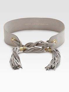 a gray leather belt with tassels and gold accents